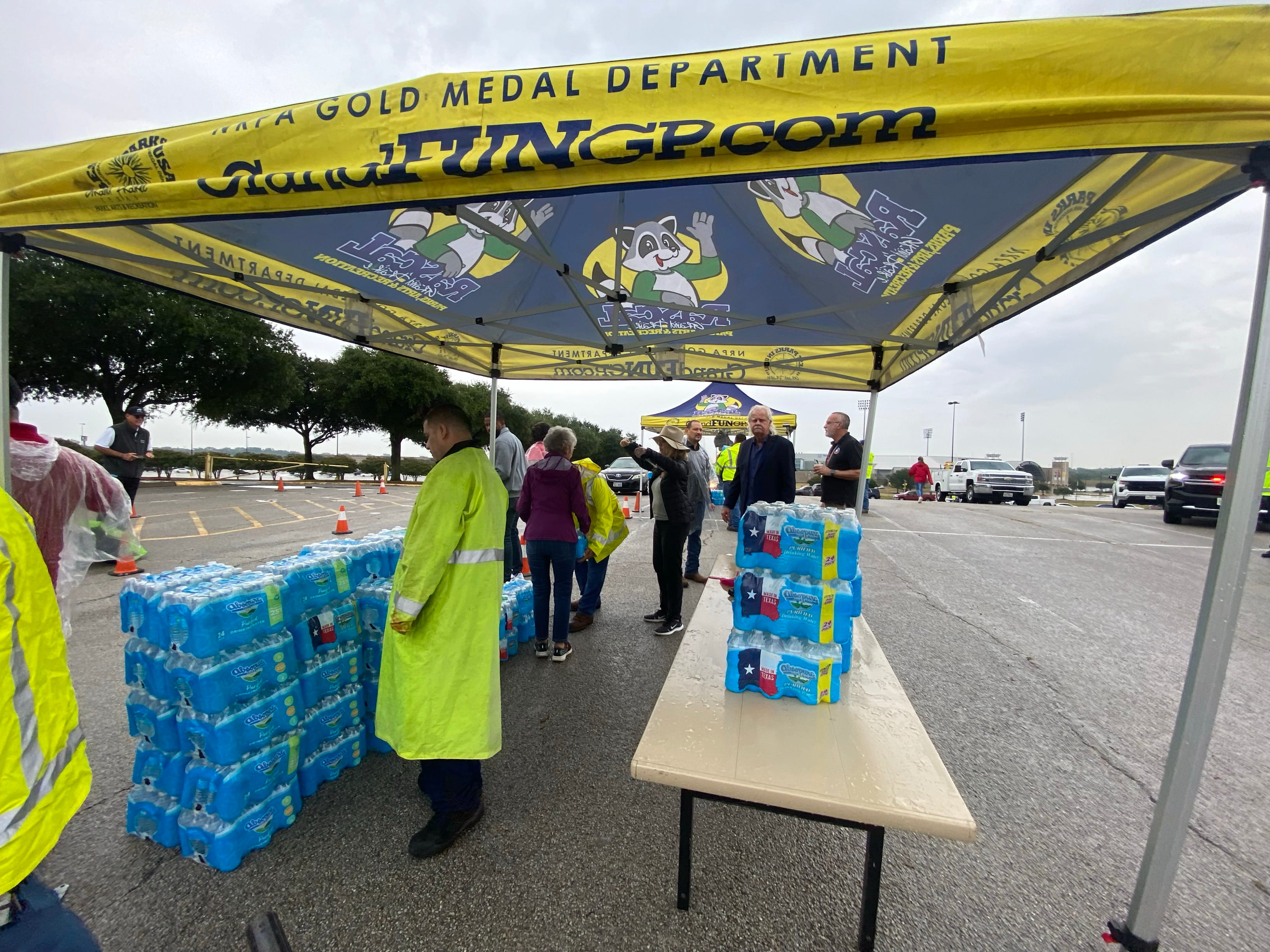 tent set up with cases of bottled water to be given to citizens during an affected water event