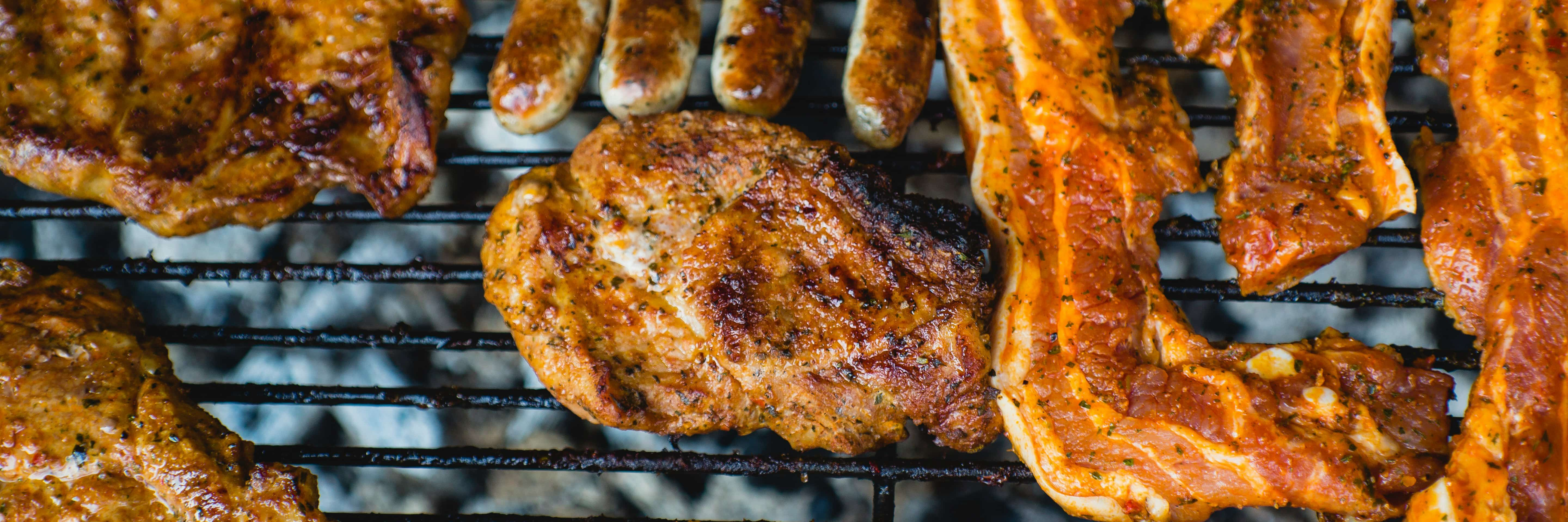 top view of chicken and bacon on grill